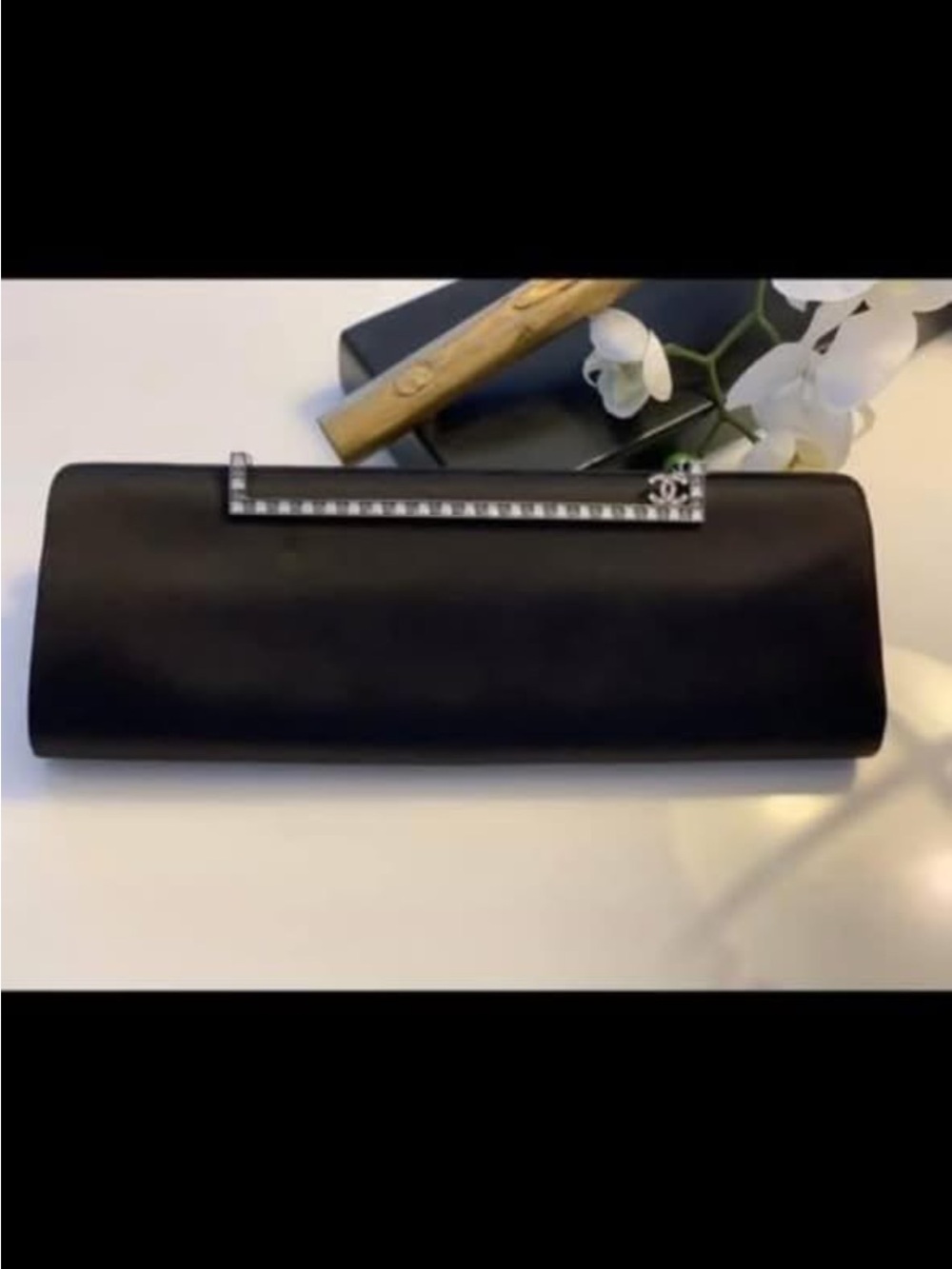 CHANEL Black Satin Clutch with Crystal-Bar Accent